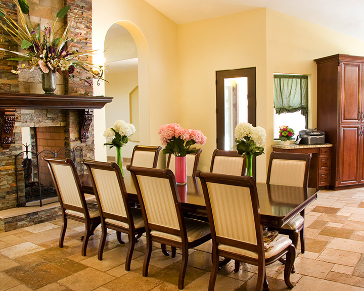 Spacious dining room with elegant tables, chairs, and warm lighting for community meals