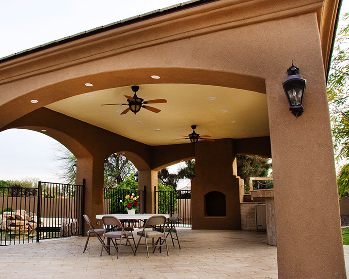 Peaceful back patio with covered seating area and beautiful desert landscaping views