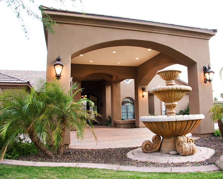 Elegant fountain feature in the main entryway surrounded by desert landscaping
