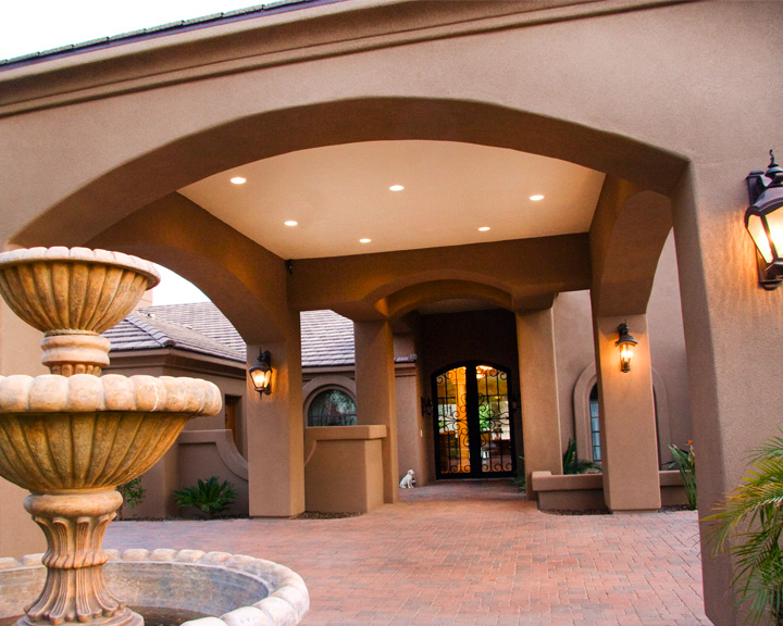 Beautiful stone entryway with covered walkway and landscaping at Scottsdale North Assisted Living
