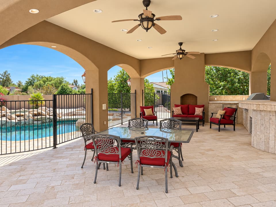 Peaceful back patio with covered seating area and beautiful desert landscaping views