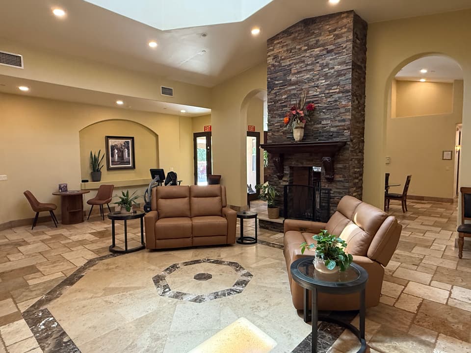 Cozy lounge area with comfortable seating, tables, and warm ambient lighting